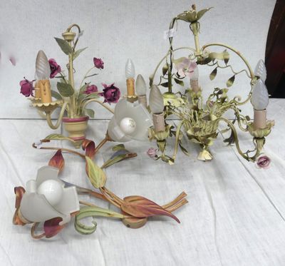 a lot of flowers and a chandelier on a table