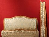 a couch and a bed in a room with a red wall