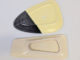 yellow and black plastic plates on a white surface