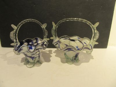 two glass vases that are sitting on a table