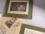 many framed pictures on the wall of a room