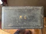 someone is holding up a book with the word m g written on it