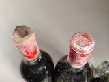 three bottles of wine that are sitting in a sink