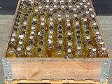 a wooden crate filled with lots of bottles of alcohol