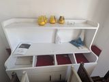 a white desk with a shelf on top of it