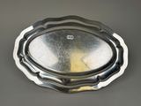 an image of a silver plate on a table with a black background