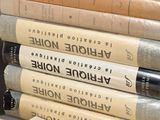 several books are stacked on top of each other on a table