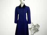 blue coat with black collar and cuffs on a mannequin base