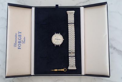 an image of a watch in a box on a marble surface