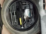 a close up of a car ' s front wheel and tire