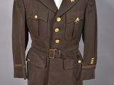 un uniforme militaire sur un mannequin, devant un fond gris