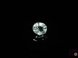 a close up of a green diamond on a black surface
