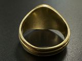 an image of a gold ring on a black surface