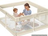 a woman holding a baby inside of a baby playpen