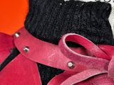 a close up of a pair of boots with a pink ribbon