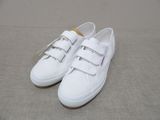 the white sneakers are lined up on the floor and ready to be worn