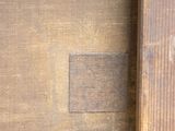 a close up of a piece of wood with a cross on it