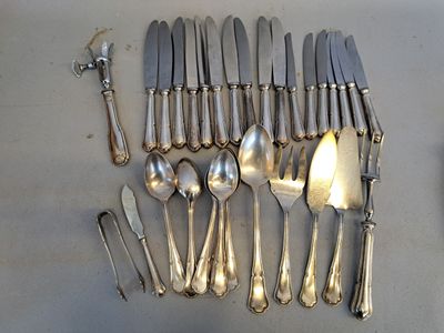 a lot of silver spoons and spoon spoons on the table