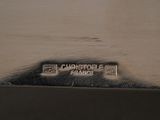 a close up of a silver plate with a name on it