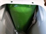 a white toilet with a green tank inside of it