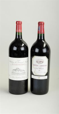 two bottles of red wine sitting next to each other on a white surface