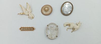 un assortiment de broches représentant notamment un cheval, un oiseau, un coquillage et une perle en forme de coquillage