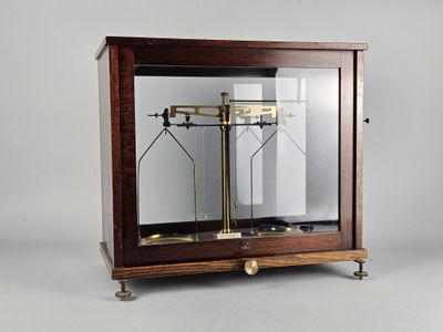 a glass display case with a clock inside of it