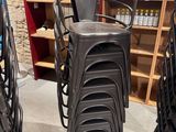 many chairs that are stacked up in a room