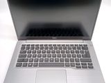 an open laptop computer sitting on top of a white table