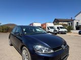 the black volkswagen golf is parked in the parking lot