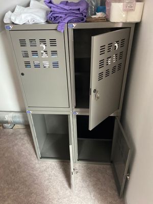 une armoire métallique à deux portes ouverte dans une salle de bains