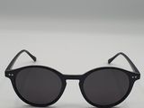a pair of black sunglasses sitting on top of a white surface