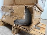 a cardboard box on a pallet with a shoe inside of it