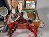 a wooden box with a bunch of jewelry inside of it