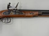un gros plan d'une arme accrochée au mur, sur fond blanc