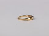 a close up of a gold ring on a white surface