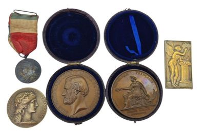 four medals and a medal in a case on a white surface
