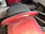 a close up of a red motorcycle with a black seat