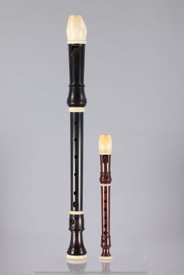 an image of a black and white flute and a brown and white flute