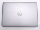 a laptop that has a cracked screen on it