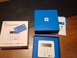 a blue box with a blue card inside of it on a wooden table
