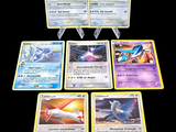 several pokemon cards sitting on top of each other on a table