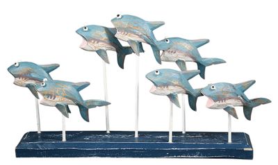 a wooden sculpture of a group of sharks on a stand