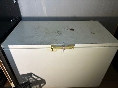 a white refrigerator sitting in a kitchen next to a stove