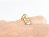 a person ' s hand with a diamond ring on it