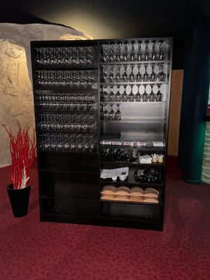a wine cooler with many wine glasses in it