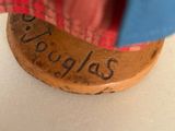 a close up of a small wooden object with writing on it