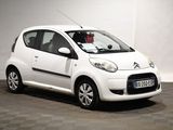 a picture of a small white car parked in a garage