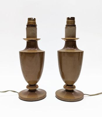 pair of brown ceramic table lamps on wooden bases on a white background