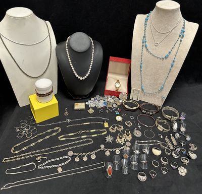 several necklaces, bracelets, and other jewelry are displayed on a table